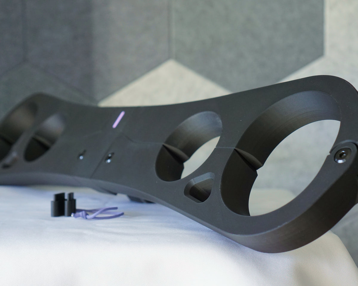 Epoch Key four-point pillory restraint in matte black, side view showing wrist and ankle openings with chamfered edges