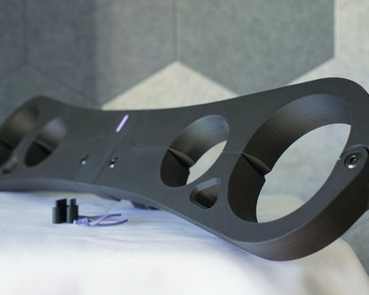 Epoch Key four-point pillory restraint in matte black, side view showing wrist and ankle openings with chamfered edges