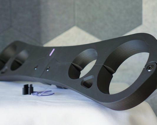 Epoch Key four-point pillory restraint in matte black, side view showing wrist and ankle openings with chamfered edges